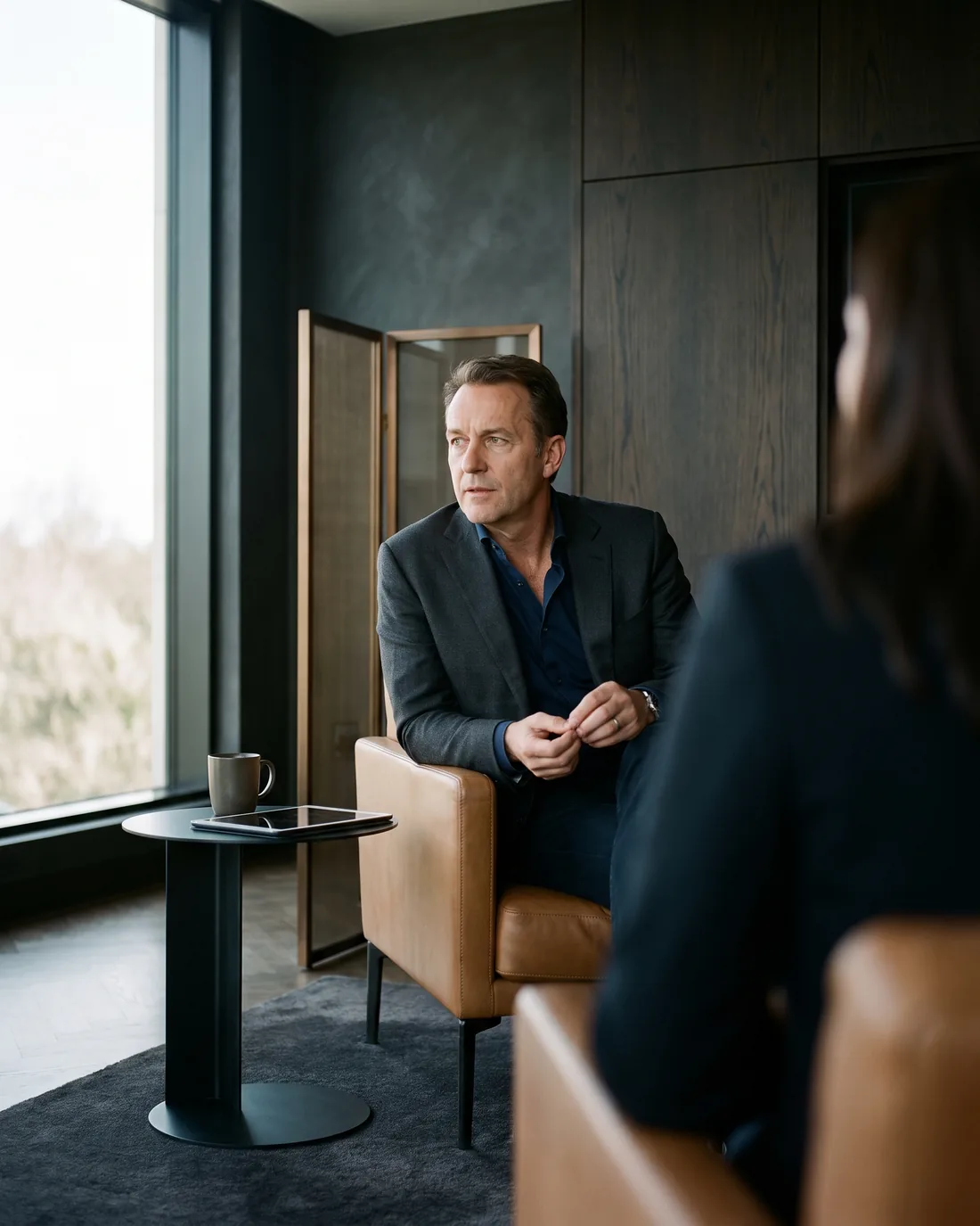 A senior CHRO reviewing the work in a calm Malta boardroom
